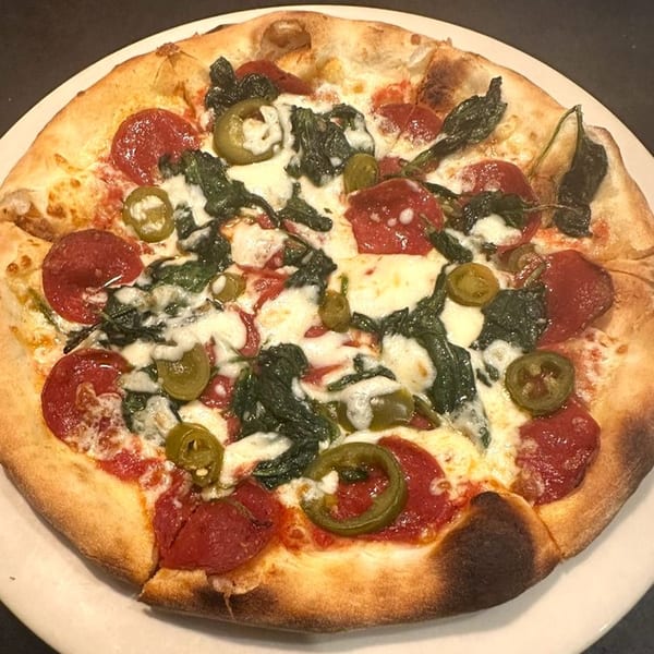 Amore Pasta & Pizza's pepperoni, spinach, and jalapeño pizza with melted mozzarella cheese.
